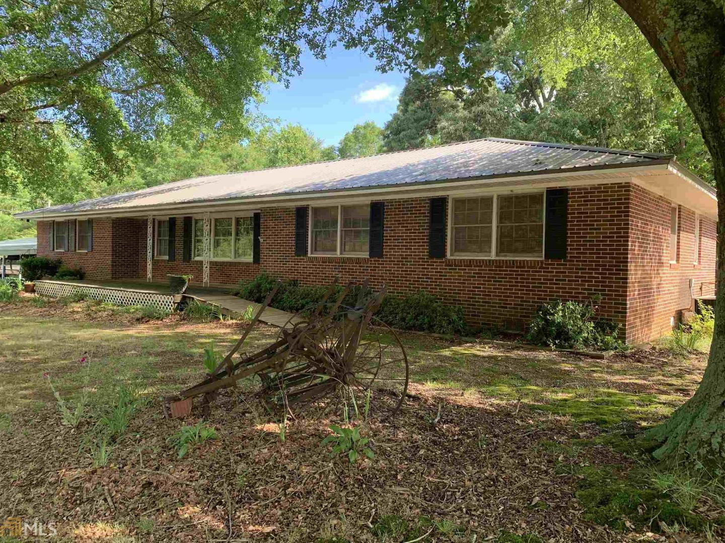 13045 Old Federal Road Carnesville, GA 30521 - Photo 1 of 1 a backyard of a house with yard table and chairs