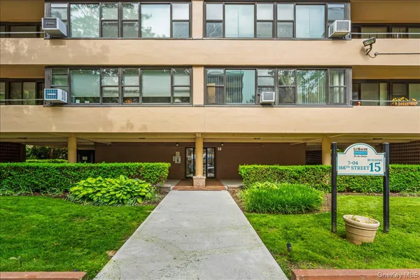 front view of a building with a garden