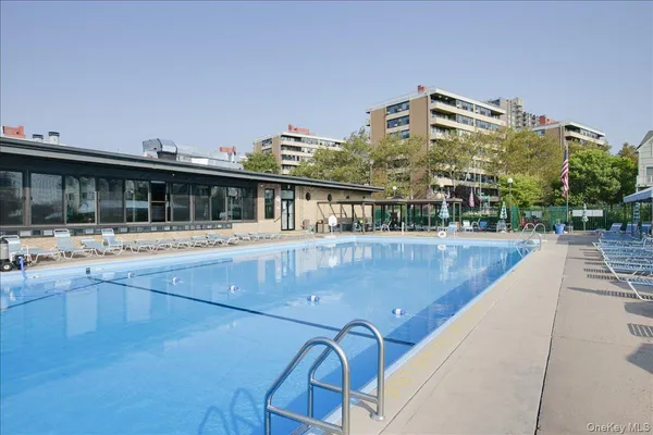 a view of a swimming pool with outdoor seating