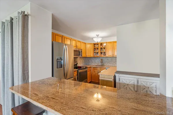 a kitchen with kitchen island a counter top space and a sink