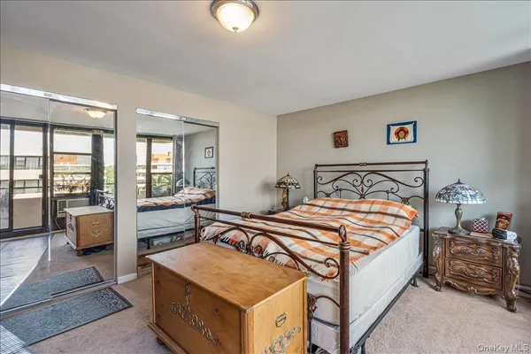 a bedroom with a large bed and a balcony view