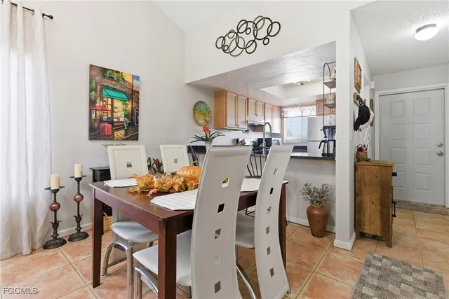 a view of a dining room with furniture and chandelier