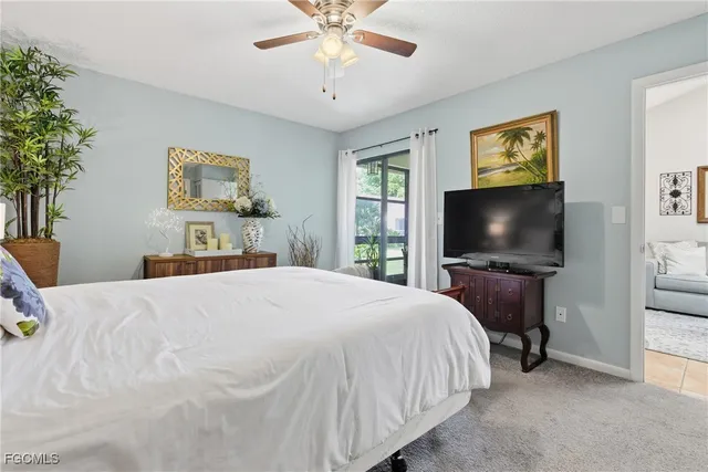 a spacious bedroom with a bed and a chandelier