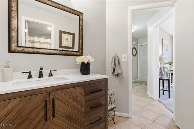 a bathroom with a sink a vanity and a shower curtain