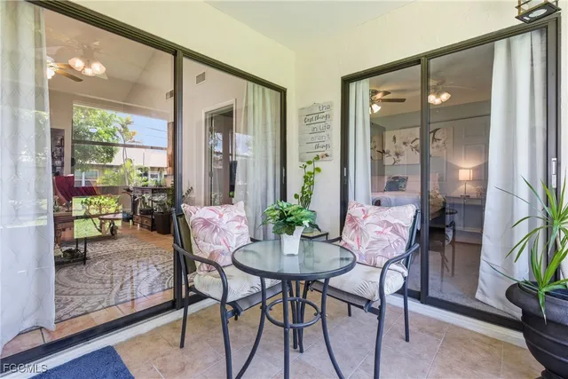 a balcony view with a potted plant and outdoor seating