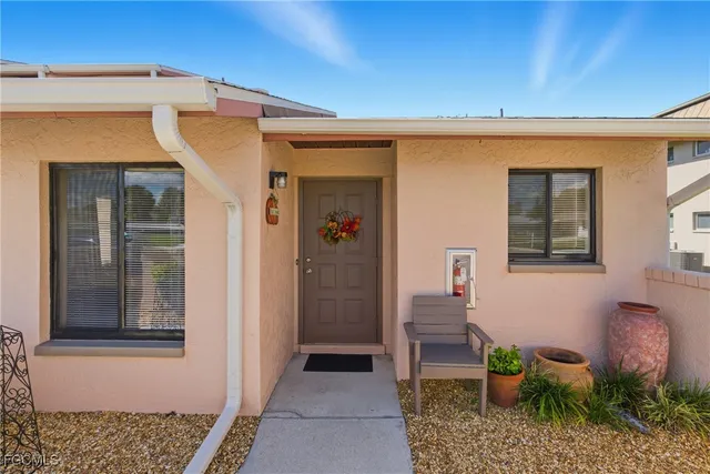a front view of a house with outdoor seating