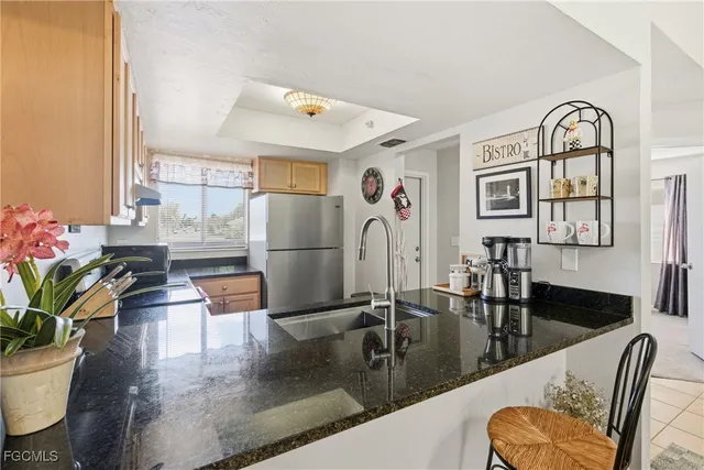 a kitchen with stainless steel appliances granite countertop a stove a sink and cabinets
