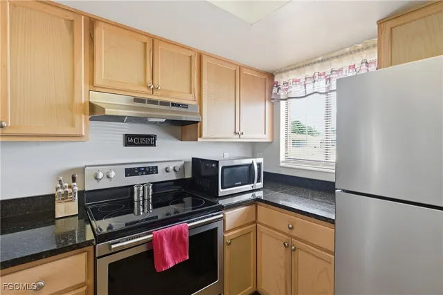 a kitchen with a sink a counter and cabinets