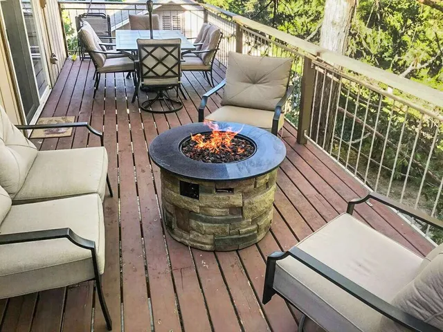 a view of a chairs and table in the balcony
