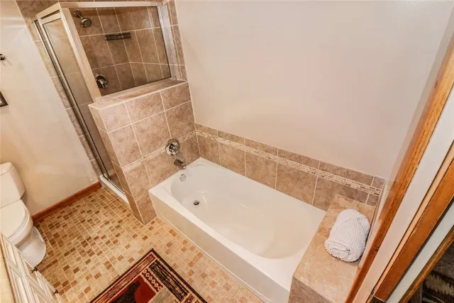 a bathroom with a shower and a glass door shower