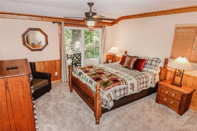 a bedroom with a bed and dresser with mirror