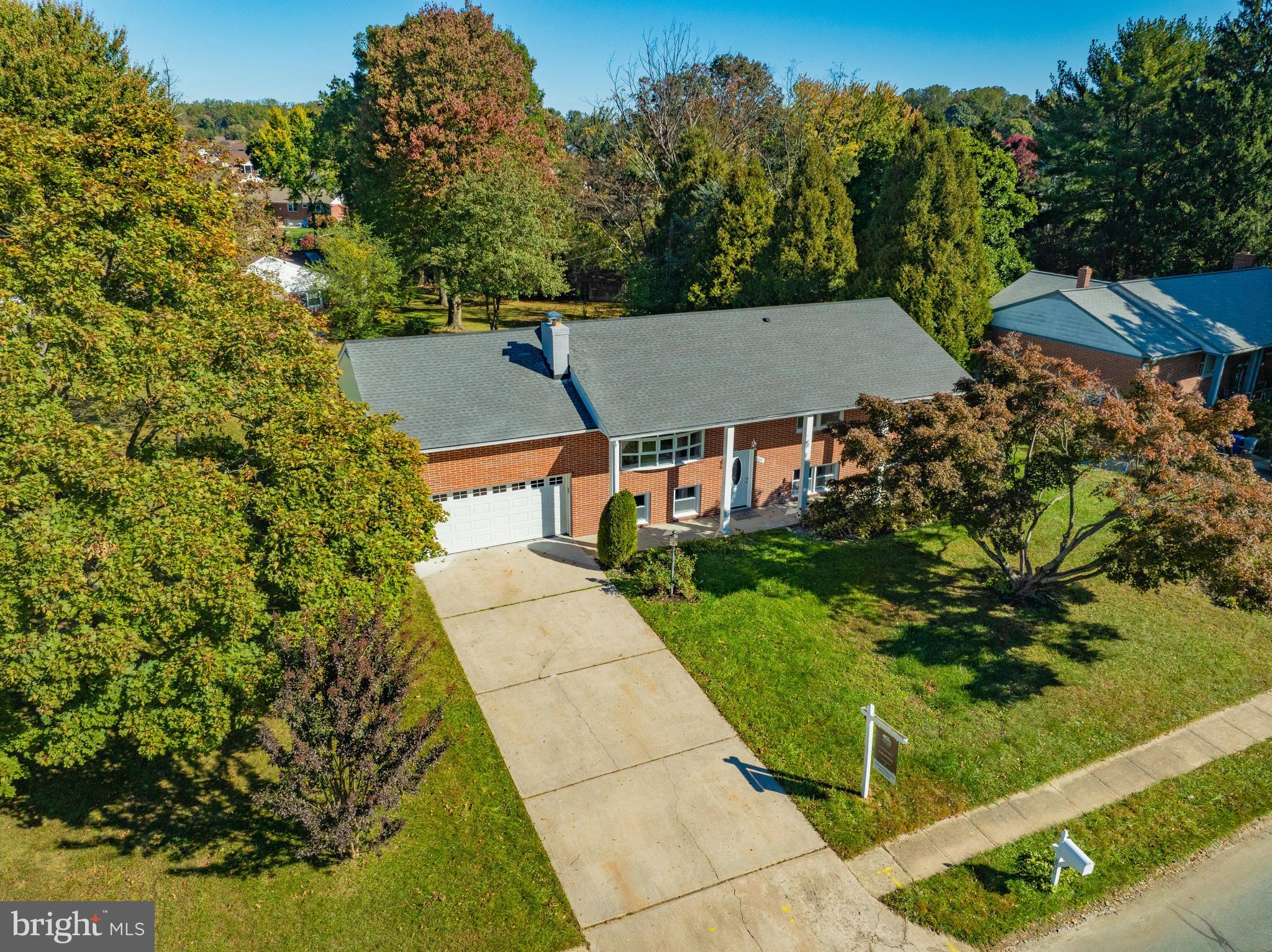 an aerial view of multiple houses with yard