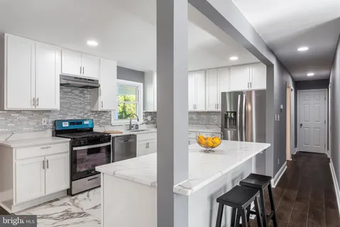 a kitchen with a sink stainless steel appliances and cabinets