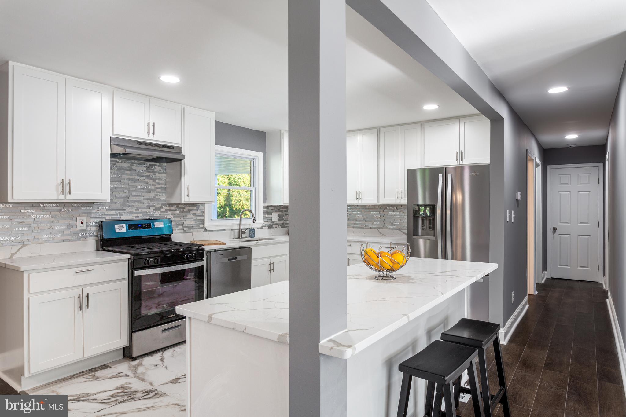 800 Flintlock Drive Bel Air, MD 21015 - Photo 11 of 55 a kitchen with a sink a stove a refrigerator and white cabinets