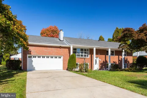 a front view of a house with a yard and a garage