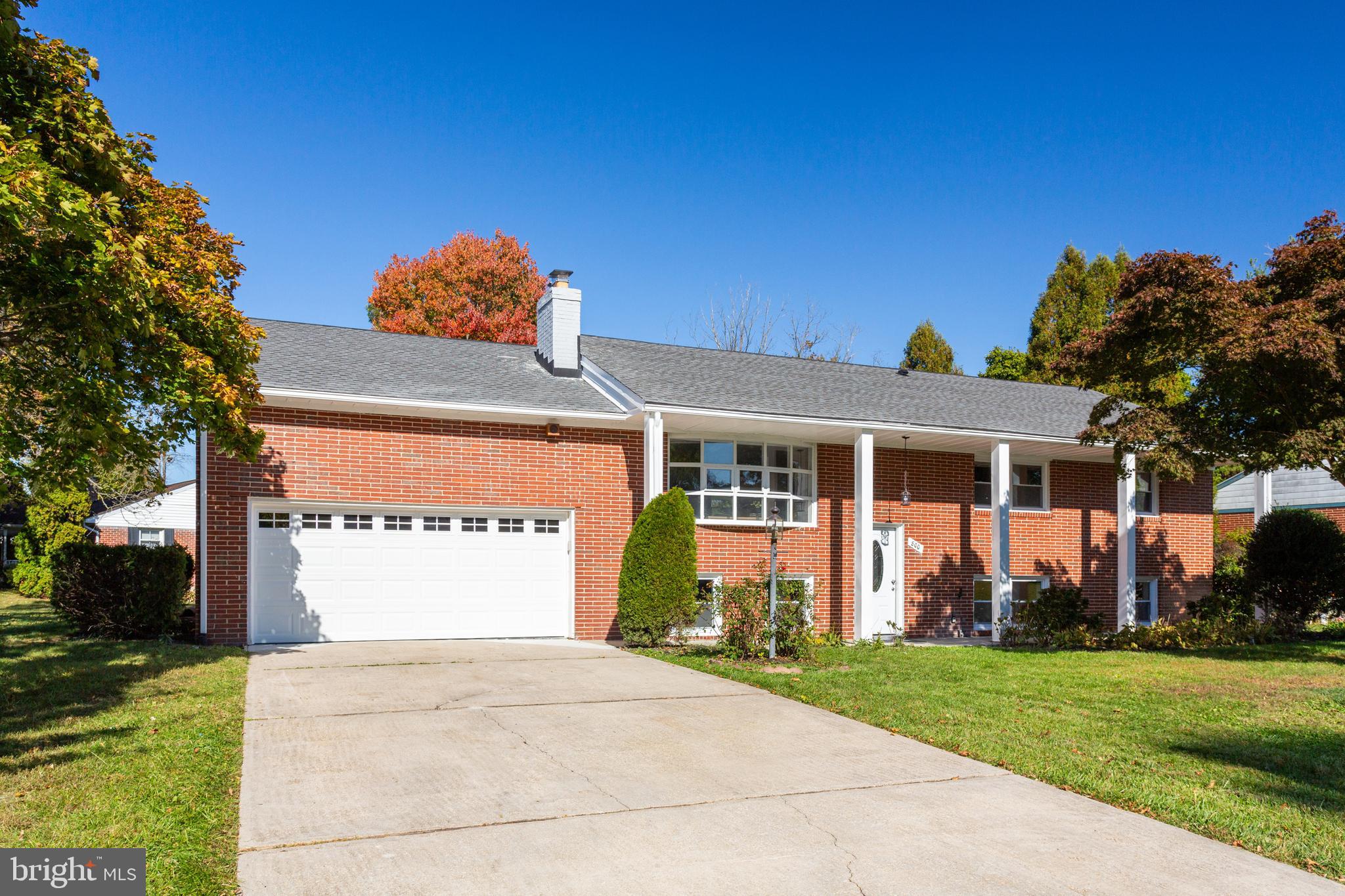 800 Flintlock Drive Bel Air, MD 21015 - Photo 3 of 55 a front view of a house with a yard and a garage