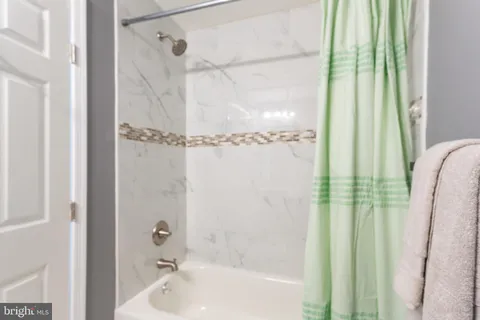 a bathroom with a sink vanity mirror and toilet