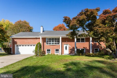 an aerial view of a residential houses with yard