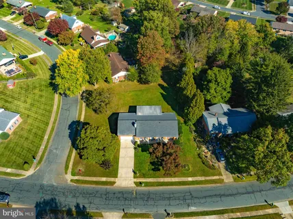 an aerial view of a residential houses with outdoor space