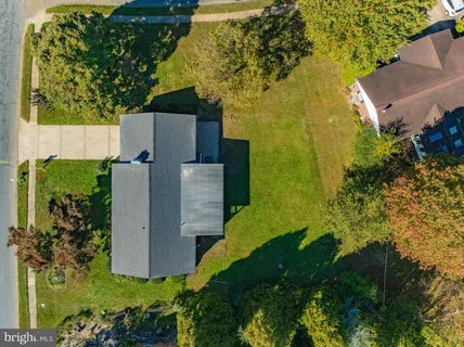 an aerial view of a house with a garden and swimming pool