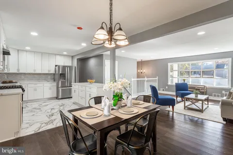 a view of a dining table chairs and chandelier