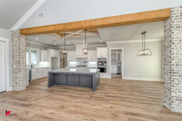a view of kitchen with kitchen island sink and refrigerator
