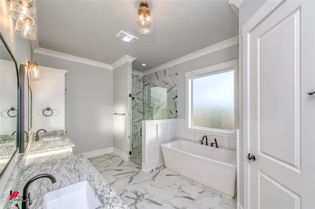 a bathroom with a granite countertop bathtub sink and mirror