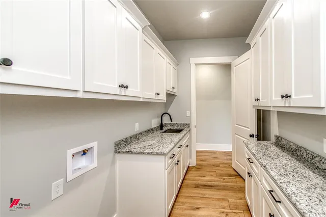 a kitchen with granite countertop a sink stove and cabinets