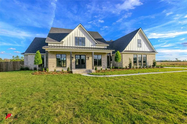 a front view of a house with swimming pool having outdoor seating