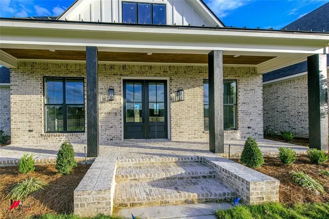 a view of a brick building with potted plants