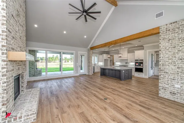 a view of a living room kitchen with a sink and a fireplace