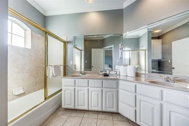 a bathroom with a double vanity sink a mirror and a bathtub