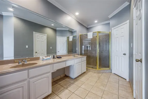 a large bathroom with a double vanity sink mirror and shower