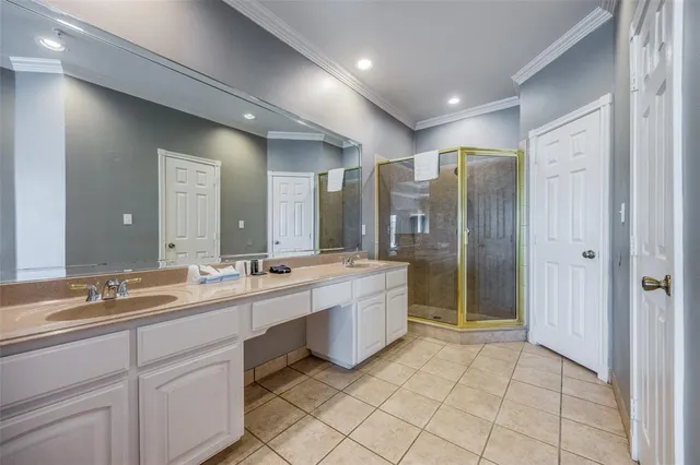 a large bathroom with a double vanity sink mirror and shower