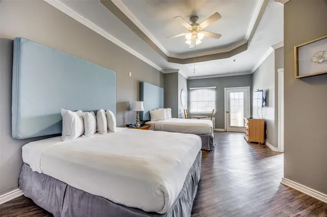 a bedroom with bed and a chandelier