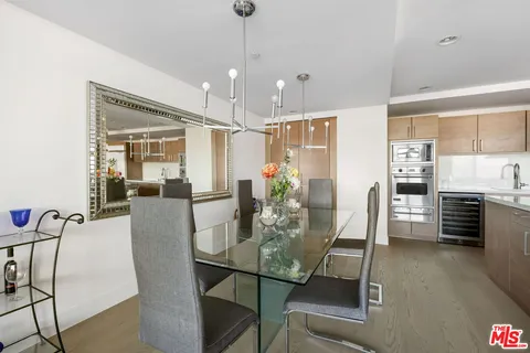 a living room with furniture a flat screen tv and a window