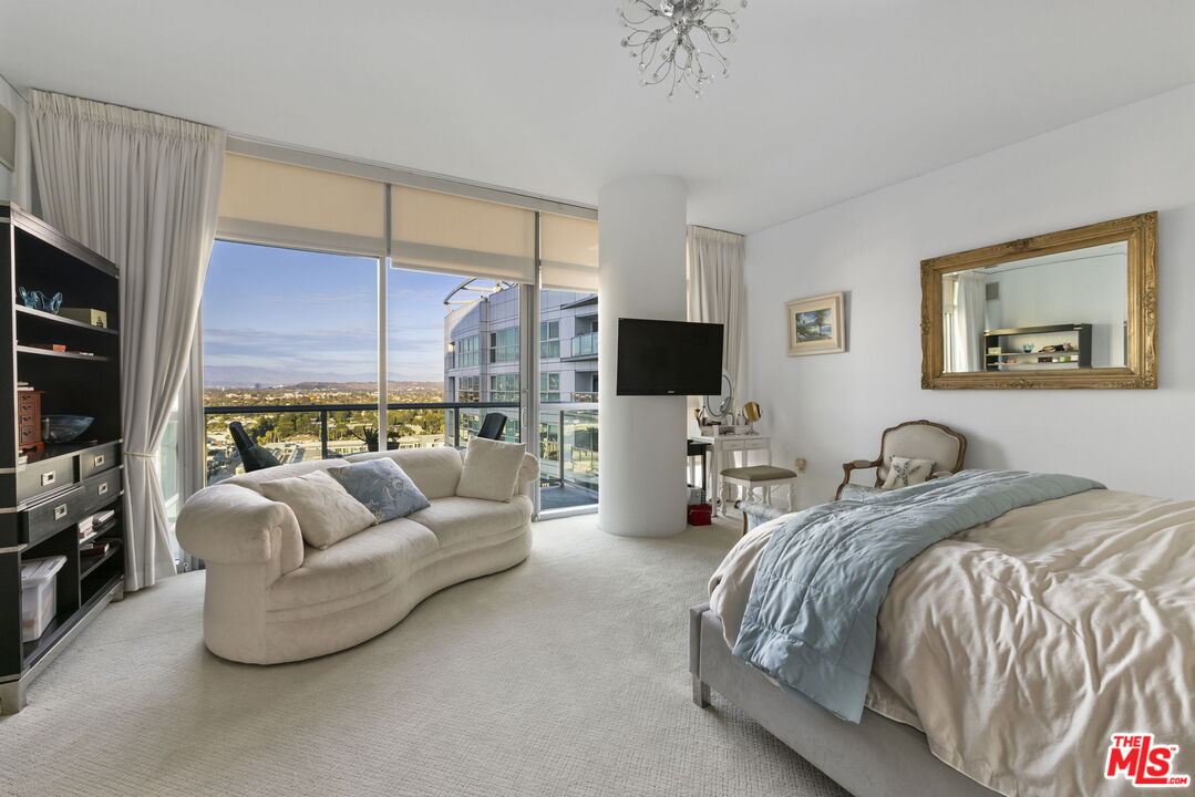 13650 Marina Pointe Drive, Unit 1806 Marina del Rey, CA 90292 - Photo 25 of 65 a living room with furniture a flat screen tv and a window