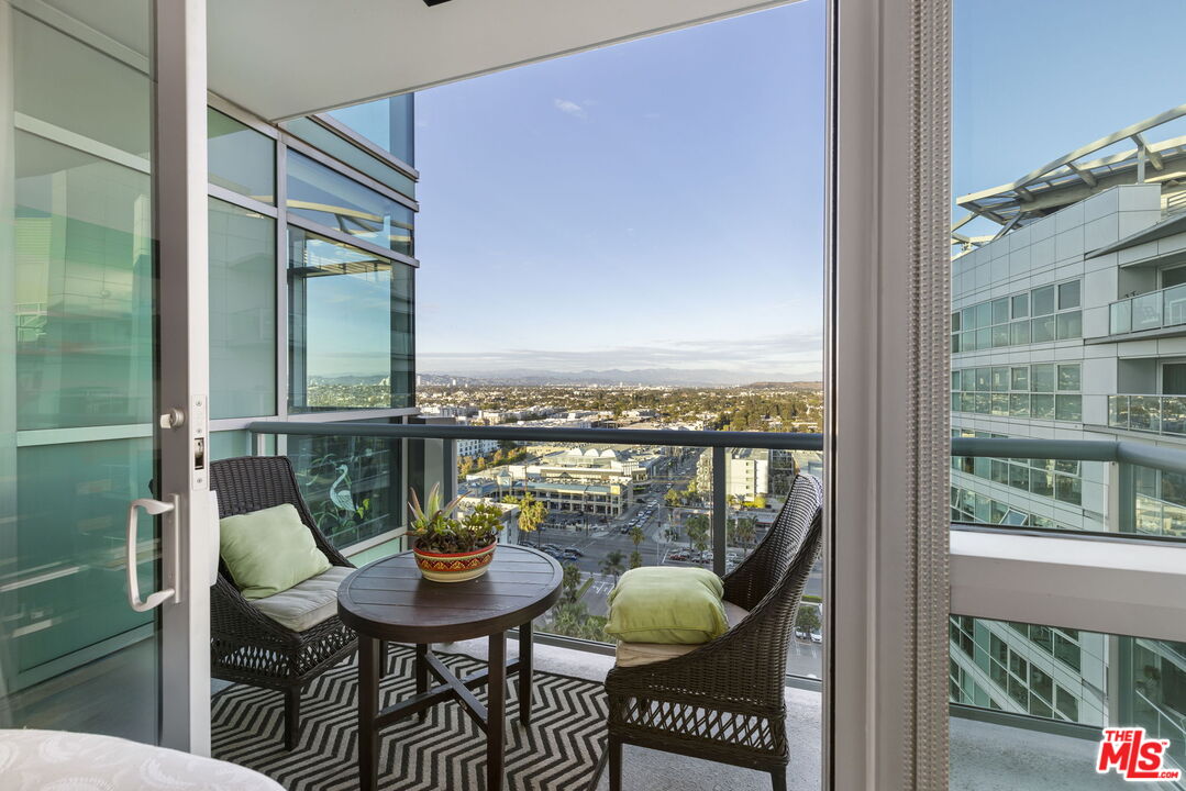 13650 Marina Pointe Drive, Unit 1806 Marina del Rey, CA 90292 - Photo 28 of 65 a balcony with table and chairs