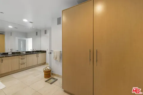 a bathroom with a granite countertop sink a toilet and a mirror