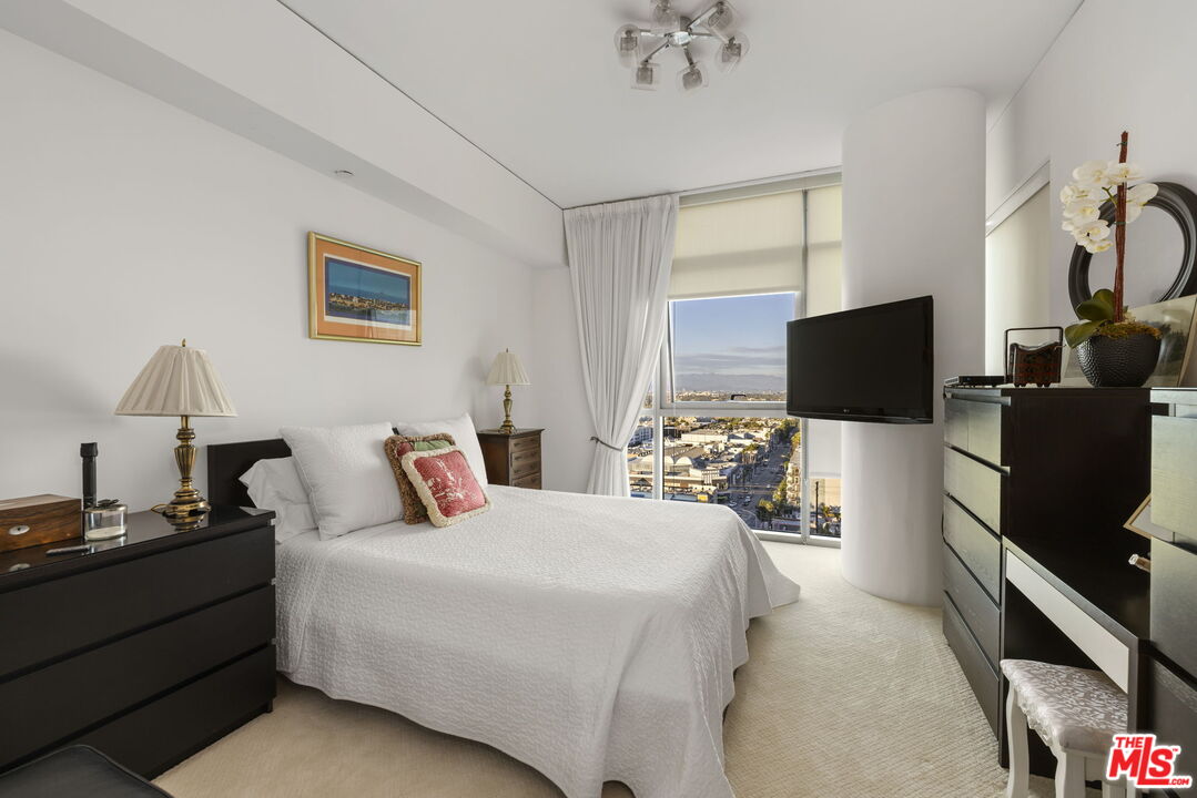 13650 Marina Pointe Drive, Unit 1806 Marina del Rey, CA 90292 - Photo 35 of 65 a bedroom with a bed and a flat screen tv