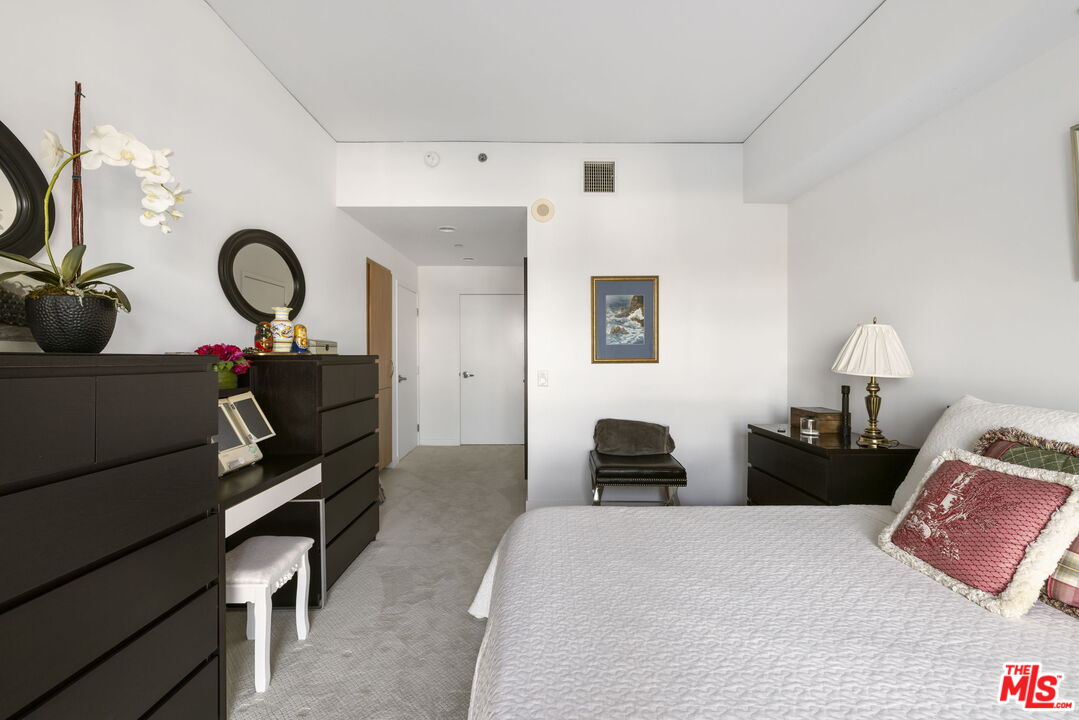 13650 Marina Pointe Drive, Unit 1806 Marina del Rey, CA 90292 - Photo 37 of 65 a bedroom with a bed and a chandelier