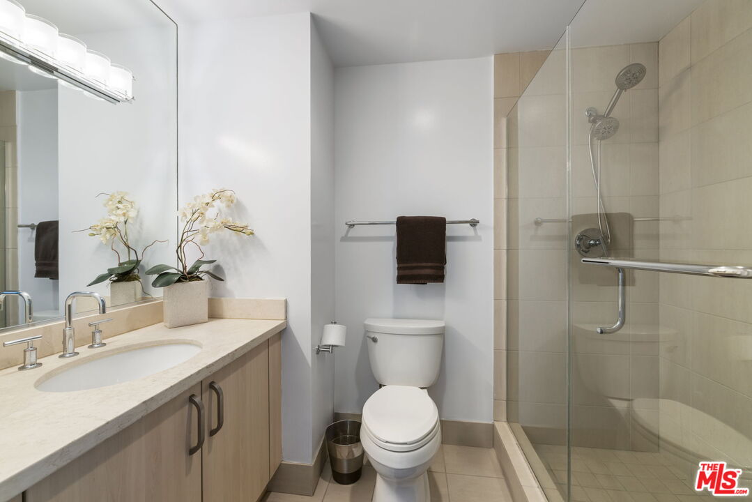 13650 Marina Pointe Drive, Unit 1806 Marina del Rey, CA 90292 - Photo 38 of 65 a bathroom with a toilet sink a shower and a mirror