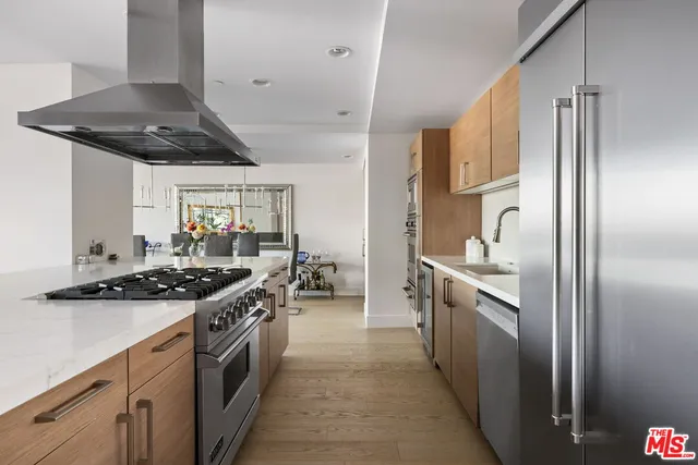 a kitchen with stainless steel appliances granite countertop a stove and a refrigerator
