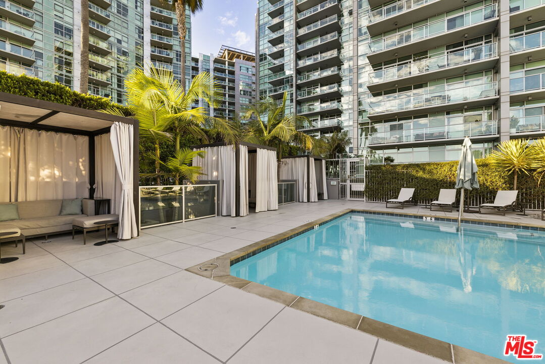 13650 Marina Pointe Drive, Unit 1806 Marina del Rey, CA 90292 - Photo 48 of 65 a view of a swimming pool with a lounge chair