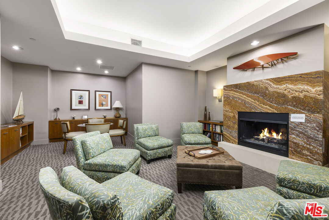 13650 Marina Pointe Drive, Unit 1806 Marina del Rey, CA 90292 - Photo 61 of 65 a living room with furniture and a fireplace