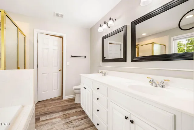 a spacious bathroom with a double vanity sink and a mirror