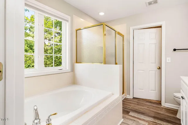 a bathroom with a bathtub and a shower