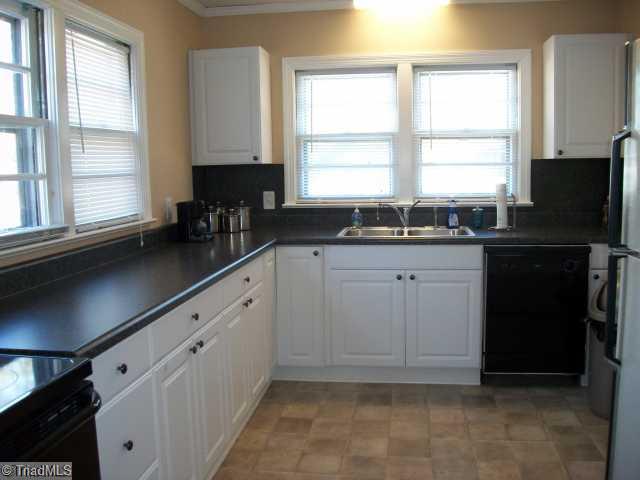 209 Guilford Road Jamestown, NC 27282 - Photo 2 of 13 Kitchen. Kitchen was updated in 2007 with cabinets, countertops, built in microwave and smooth top range.
