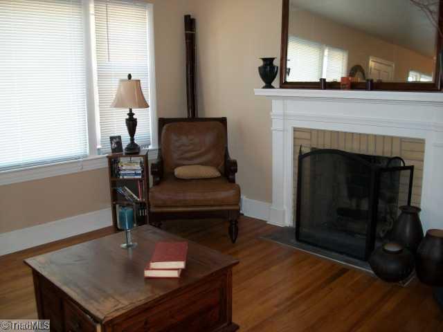 209 Guilford Road Jamestown, NC 27282 - Photo 5 of 13 Living Room. The living room features a wood burning fireplace.