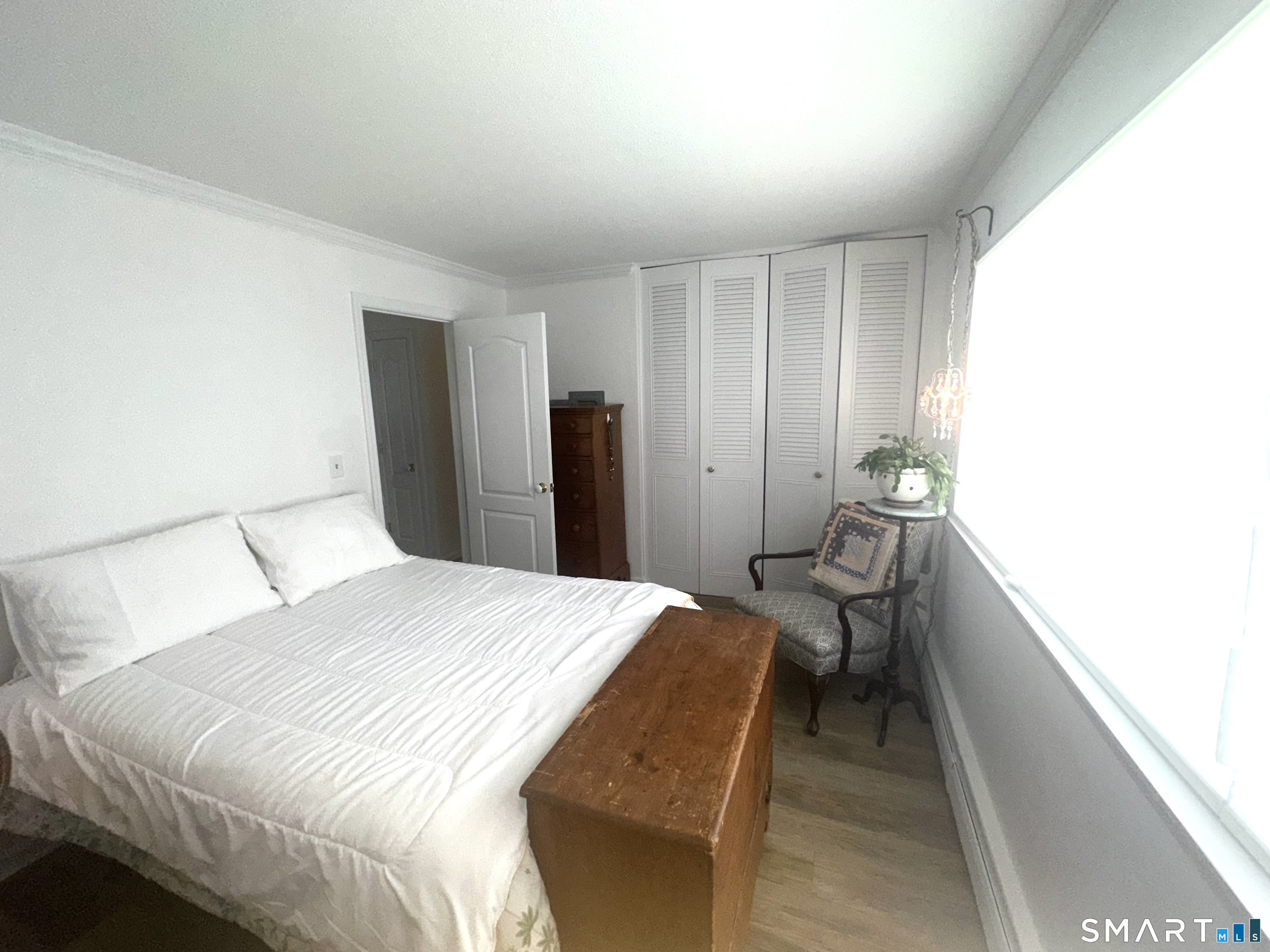 126 Sherman Hill Road, Unit C14 Woodbury, CT 06798 - Photo 11 of 27 a bedroom with a bed and a table
